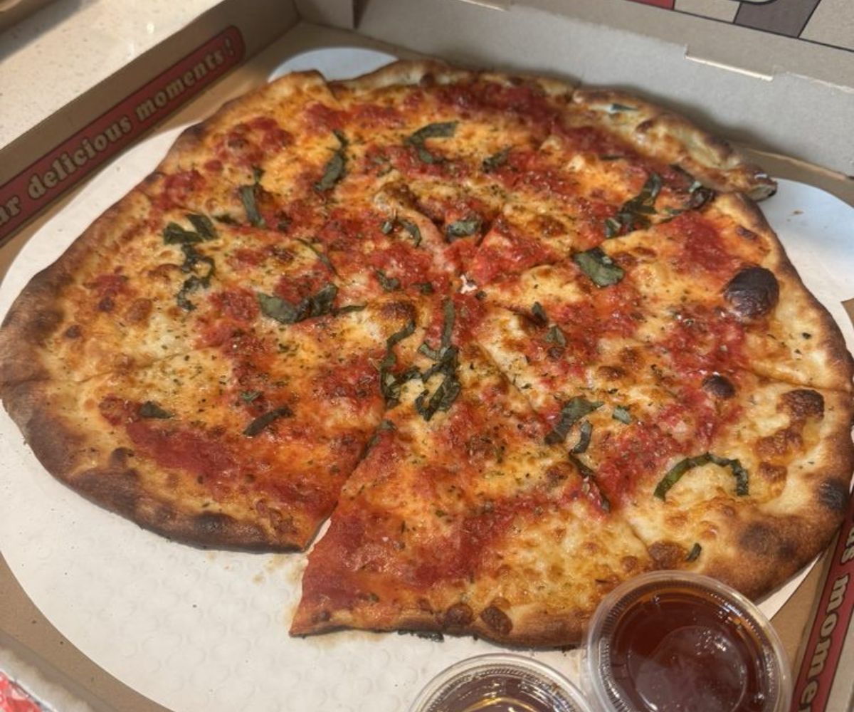 Skorch'd Pizza Nothin Plain About It with a side of Hot Honey