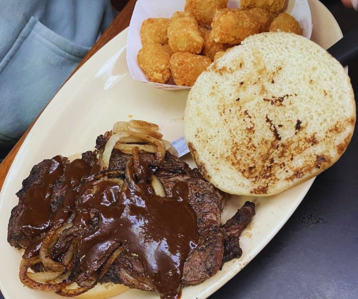 Stockyard Grill - Steak Sandwich with Top Bun Lifted & Tater Tots