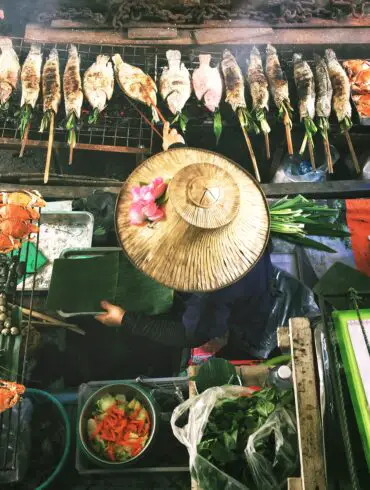 overhead view of a vendor grilling food