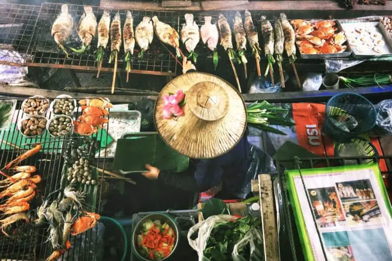 overhead view of a vendor grilling food