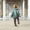 kid walking under a bridge