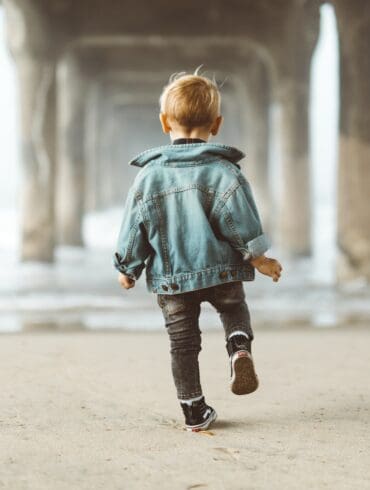 kid walking under a bridge