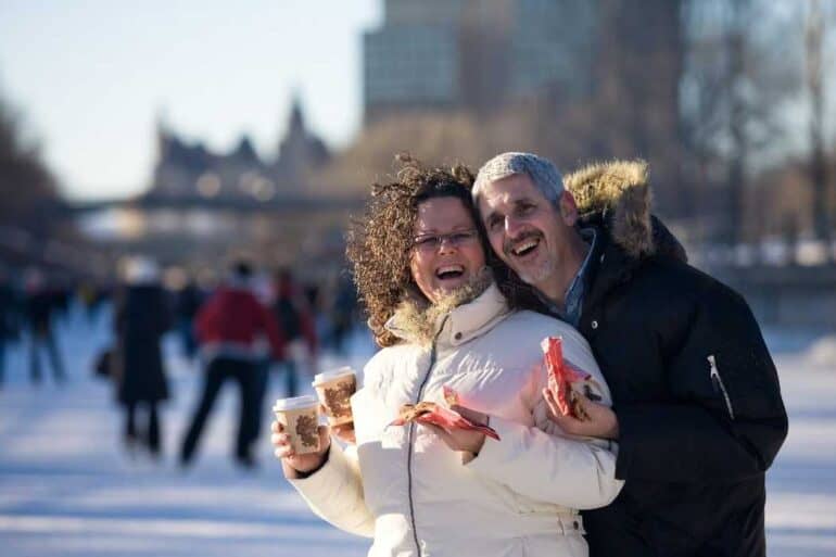 Middle aged couple on the Rideau Canal drinking hot chocolate