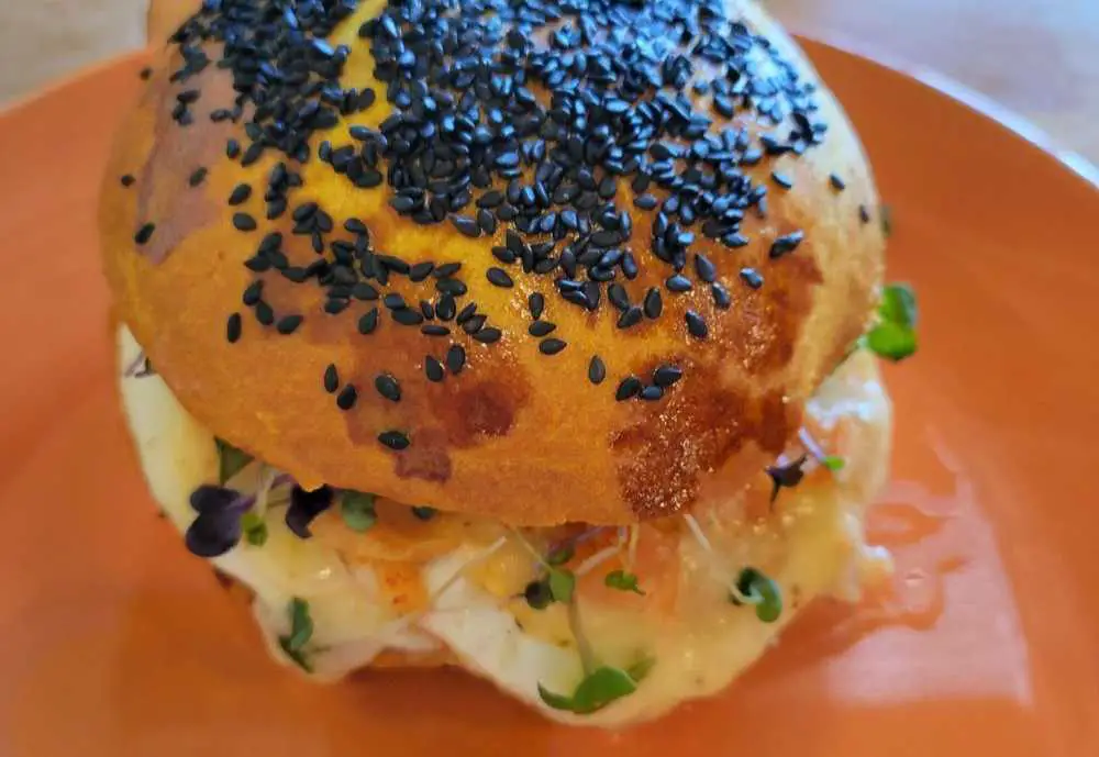 Breakfast sandwich w/egg, kimchi, sprouts, cheddar on sweet potato brioche bun at Trailside Bakery Cafe in Boise Idaho