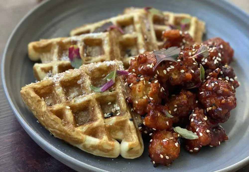 Waffles and Korean Gochujang Chicken at Benchmark Restaurant in Santa Ana, California