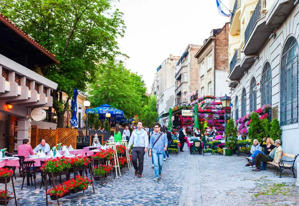 tourists walking alongside a European Cafe in Serbia