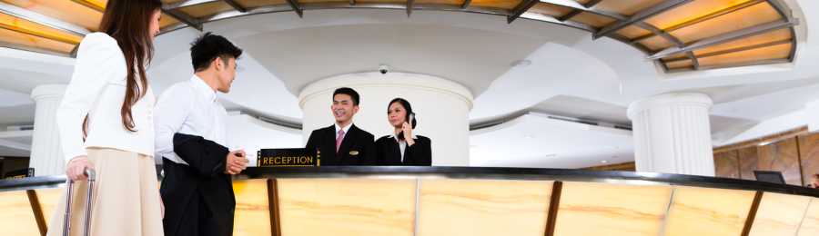 a couple checking into a hotel