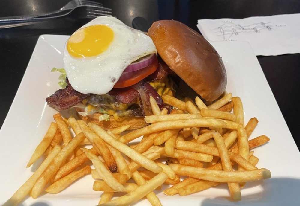 Burger with fried egg and fries at the Pint House Burgers and Brews in Asheville, North Carolina