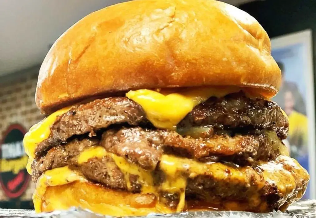 A massive triple cheeseburger at That Burger Spot So Extra! in Atlanta, georgia