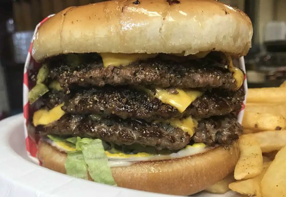 huge triple cheeseburger at Top of the Hill - Greasy Burger in College Station, Texas