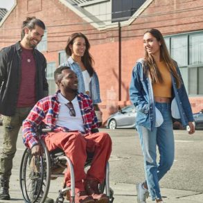 man in wheelchair with friends
