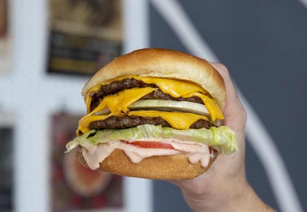 A huge triple cheeseburger at Nonla Burger in Kalamazoo, Michigan