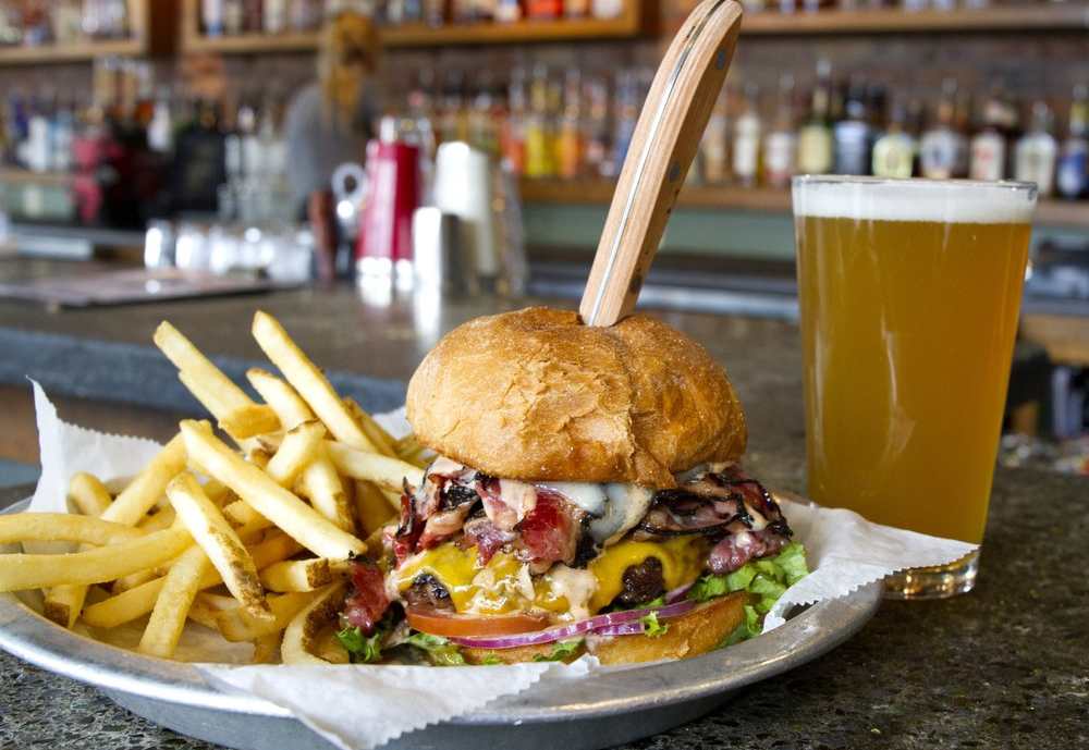 Loaded cheeseburger with fries and pint of beer at Lumberyard Tap Room & Grill in Flagstaff Arizona