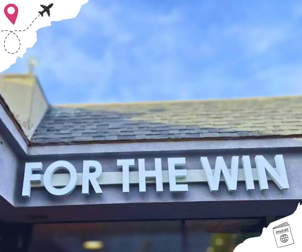 "For the Win" is white in all caps on the front of the restaurant building.