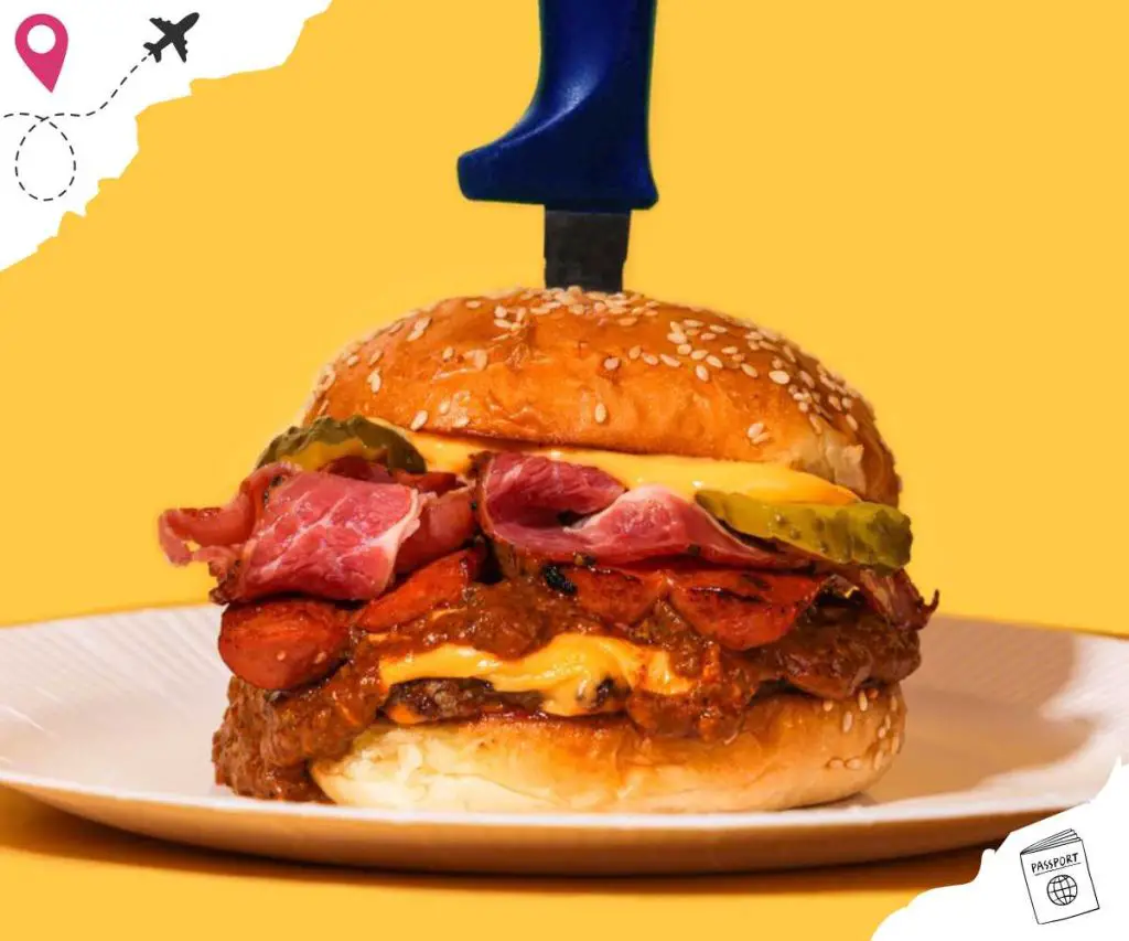 Burger on a plate with a yellow background