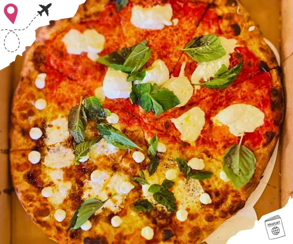 A pizza with two different sides of toppings.