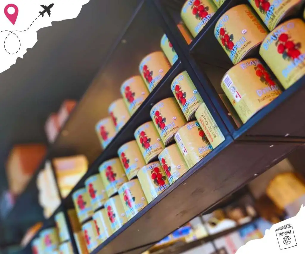 Shelves full of large cans of tomato sauce.
