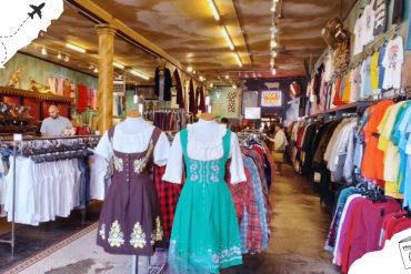 Vibrant thrift store interior showcasing traditional and vintage clothing, accessories, and souvenirs, perfect for travelers seeking unique shopping experiences in popular travel destinations.