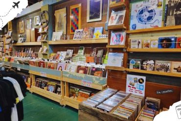 Vintage record store with a wide selection of vinyl records, music CDs, and artwork for sale, perfect for music enthusiasts and collectors exploring travel and culture destinations.