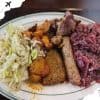Succulent Ethiopian cuisine platter with injera, seasoned meats, and spicy cabbage, showcasing authentic flavors and traditional ingredients for a memorable dining experience.