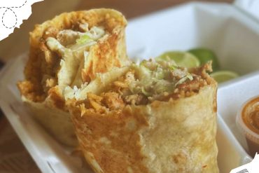 Vegetarian burritos with crispy tortilla wrapping, filled with seasoned vegetables and cheese, served with lime wedges and salsa, ideal for travel food lovers.