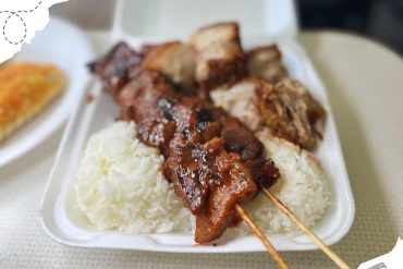 Juicy grilled meat skewers served over white rice, showcasing authentic cuisine from travel destinations, perfect for food lovers exploring global flavors.