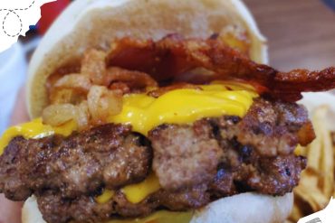 Juicy cheeseburger with grilled beef patties, melted cheese, crispy bacon, and savory toppings, served in a soft bun, perfect for burger lovers.