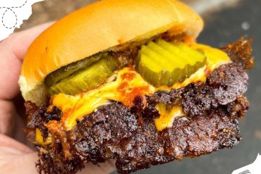 Crispy fried chicken sandwich with pickles and melted cheese, delicious street food from the USA.