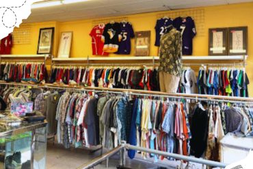 Clothing store with racks of colorful apparel, sports jerseys, and accessories, perfect for finding trendy travel souvenirs or packing essentials for your next destination.