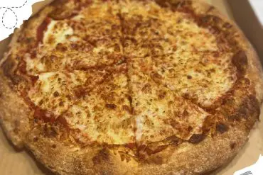 Fresh baked pepperoni pizza in a box showcasing delicious cheesy toppings and a crispy crust. Perfect for travel and dining experiences at top destinations.