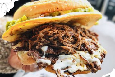 Gourmet taco with shredded beef and toppings, popular food travel destination, street food cuisine, flavorful Mexican dish, delicious street food in Mexico.