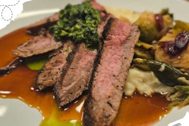 Juicy grilled steak with broccoli, mashed potatoes, and vegetable medley on white plate, featuring savory sauce for a delicious meal. Perfect for food lovers and gourmet dining experiences.