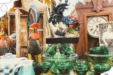 Colorful vintage glassware, wooden rooster and clock, and eclectic décor at a thrift shop or antique store. Perfect for travel destinations, shopping, and unique souvenirs.