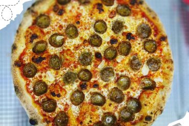 Fresh baked pepperoni pizza with melted cheese and crispy crust, perfect for travel destinations and food lover adventures.