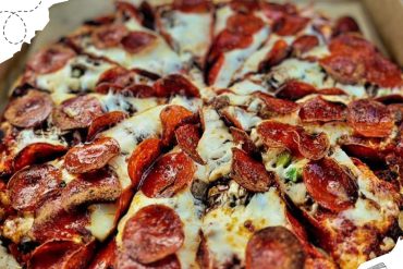 Authentic pepperoni and sausage pizza with melted cheese, fresh toppings, and crispy crust from a pizzeria in Italy. Perfect for pizza lovers and travel food enthusiasts.