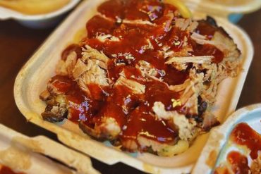 Savory pulled pork tacos with barbecue sauce in eco-friendly takeaway containers, close-up of Mexican street food, delicious and flavorful meal for travel and dining experiences, Go To Destinations food photography.