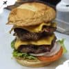 Juicy double beef cheeseburger with cheddar, fresh lettuce, tomato, onions, and toasted bun, perfect for burger lovers and fast food enthusiasts.