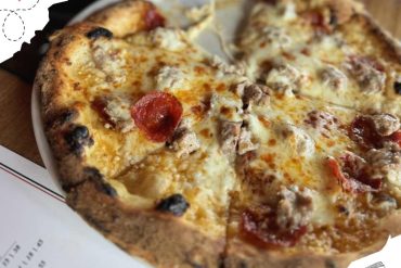 Delicious cheese and pepperoni pizza with savory toppings, served hot on a pizza box, ideal for food lovers and restaurant dining. Perfect for showcasing Italian cuisine and comfort food.