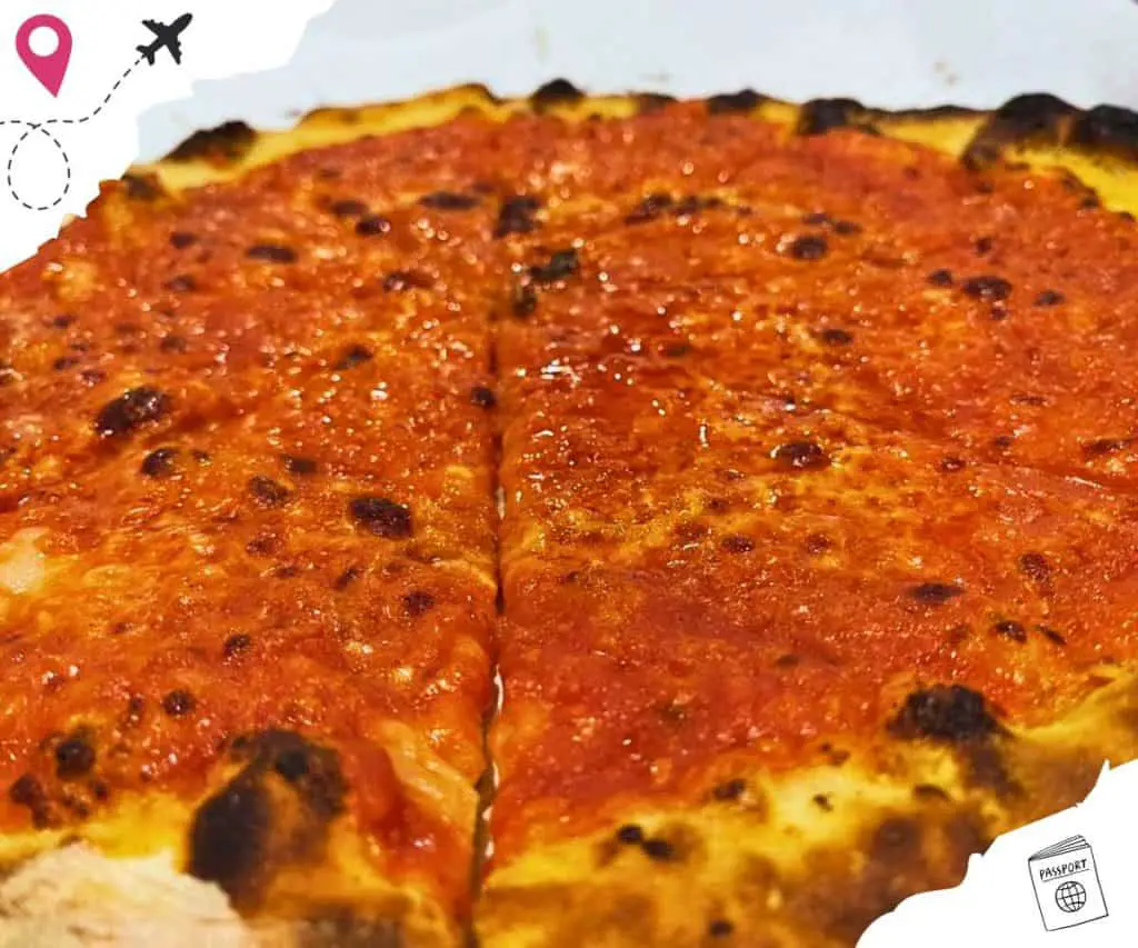 A pizza with just tomato sauce.