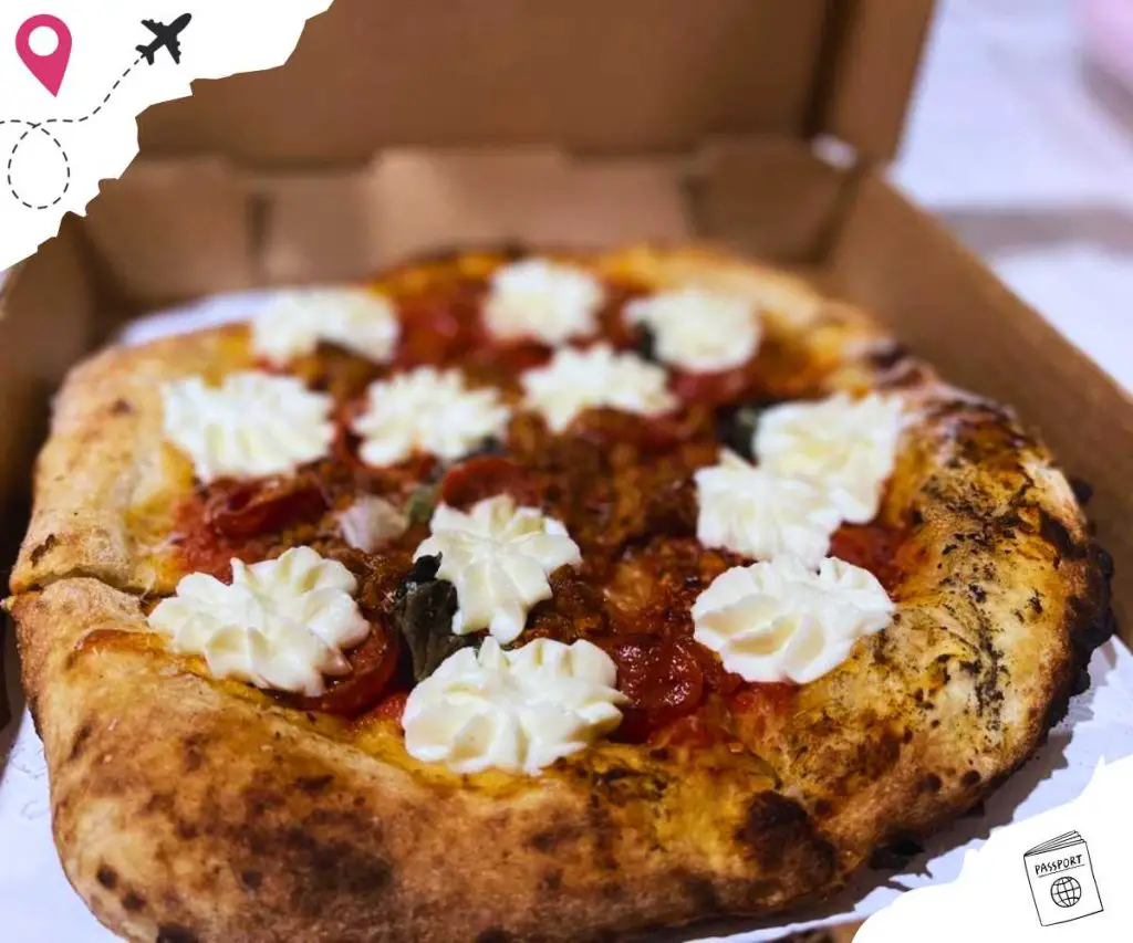 Freshly baked pizza with mozzarella and pepperoni served in a takeout box, perfect for travel and food enthusiasts exploring best destinations for culinary delights.