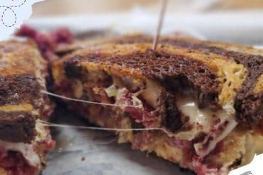 Delicious layered berry and custard dessert with chocolate and creamy filling, close-up, appealing sweet treat, perfect for travel destinations food photography, indulgent comfort food, close-up of dessert piece on plate, tasty dessert with fresh berries and whipped cream.