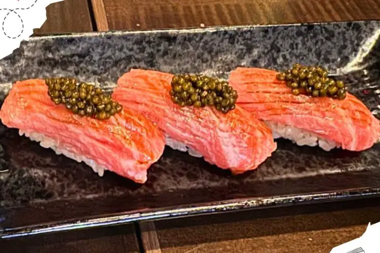 Three pieces of sushi topped with caviar.
