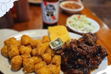 Korean fried chicken with rice cake and side dishes at a restaurant in South Korea.