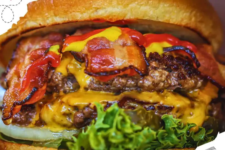 Close up of a cheeseburger with bacon.