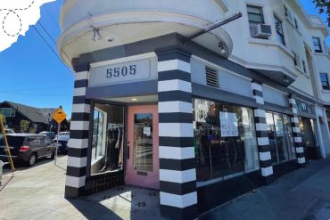 Modern boutique store located at 5505 with stylish black and white striped exterior, large glass windows, and a pink door, perfect for shopping adventures.