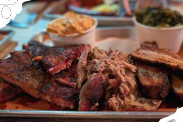 Smoked barbecue ribs served with sides including collard greens and mac and cheese, highlighting Southern cuisine and American barbecue dining experiences.