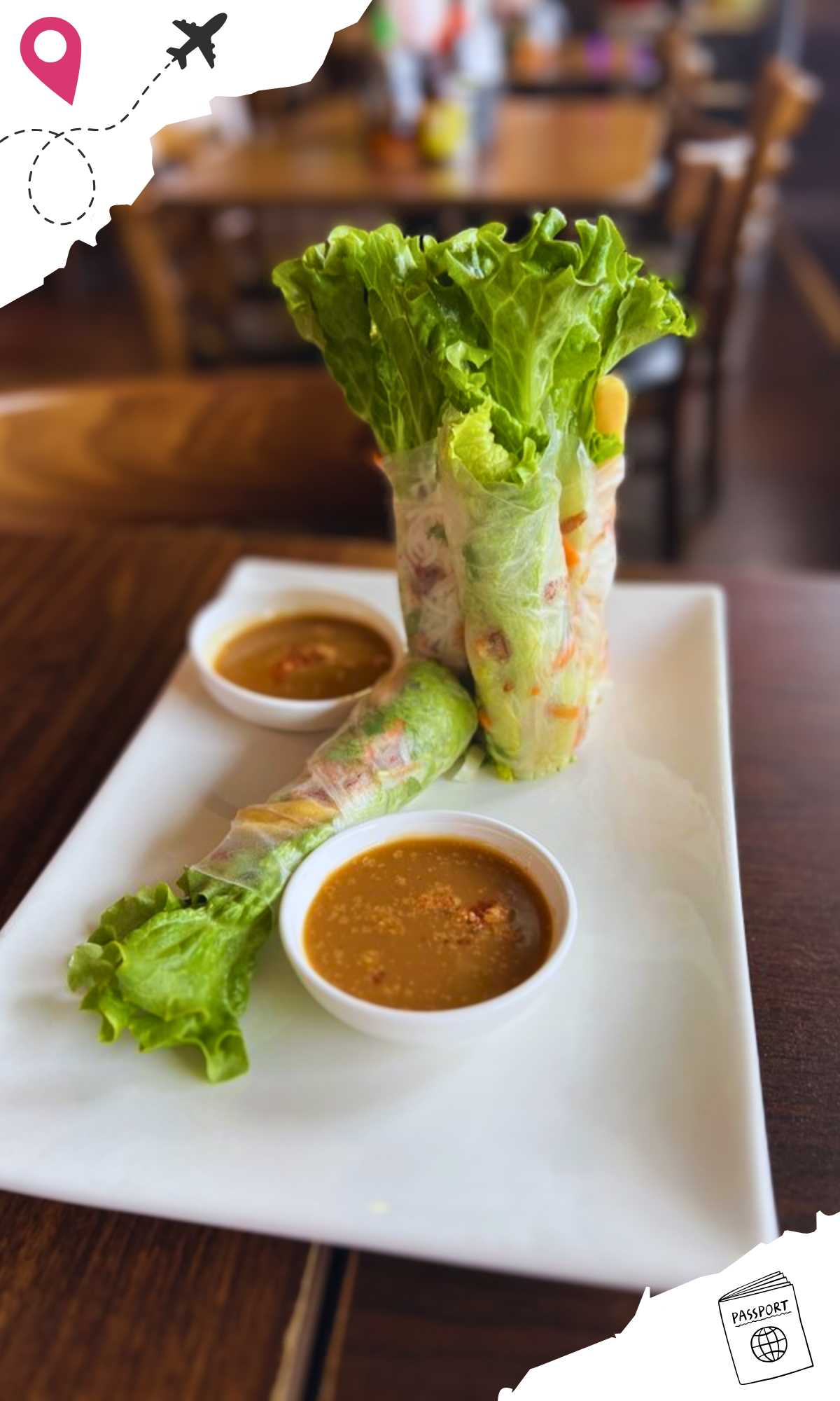 Two spring rolls standing up on a plate with two bowls of sauce and another spring roll lying down.