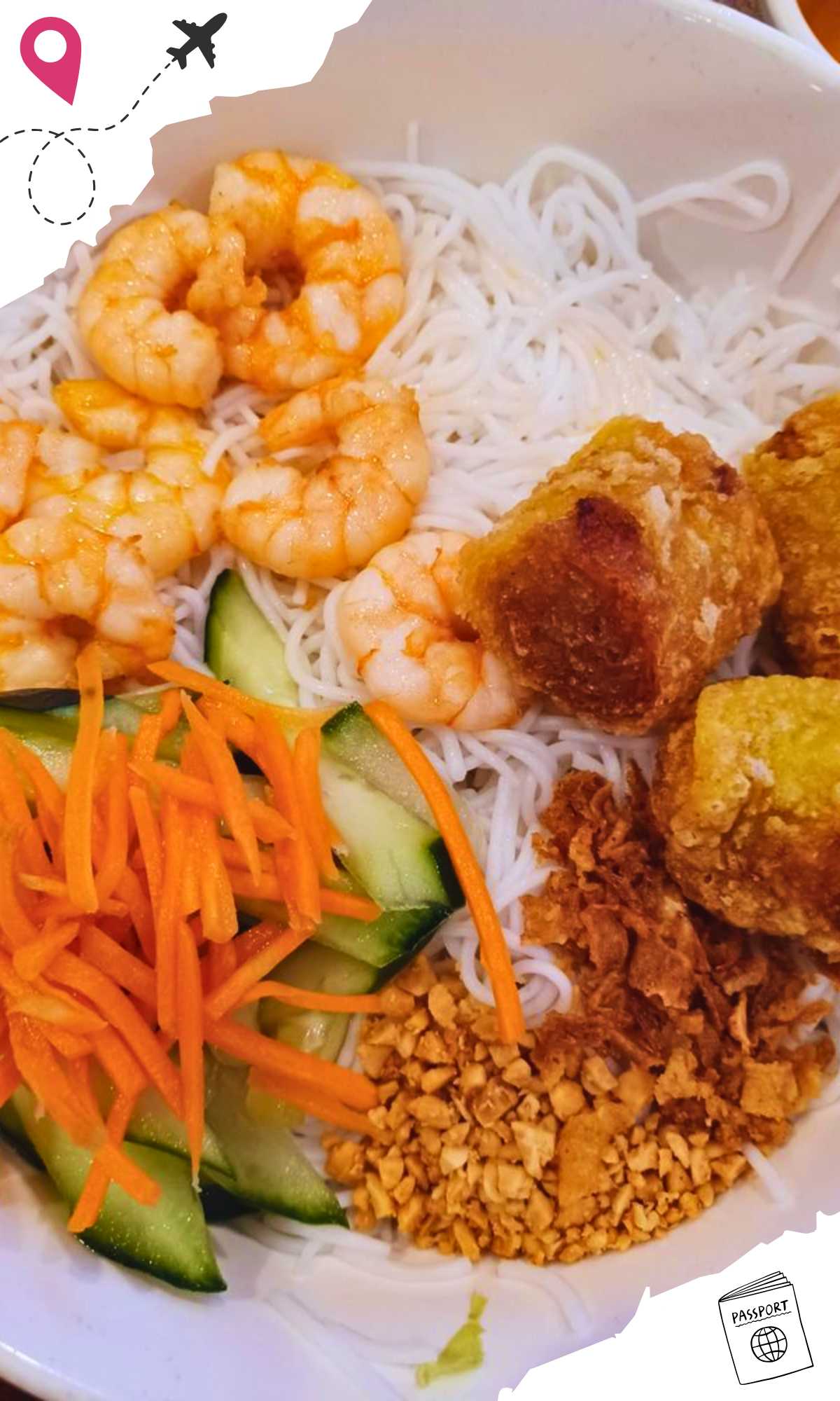 Shrimp, fried spring rolls, crushed nuts, fresh vegetables and vermicelli in a bowl.