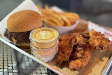 Crispy fried chicken with burger and fries on tray, fast food meal, American cuisine, comfort food, takeaway, Goto Destinations travel food experience, delicious dining, casual dining, food photography.