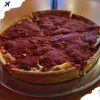 Spicy pepperoni pizza with melted cheese on a classic crust served on a silver platter, showcasing authentic flavors and delicious toppings. Perfect for sharing in an Italian or casual dining setting.
